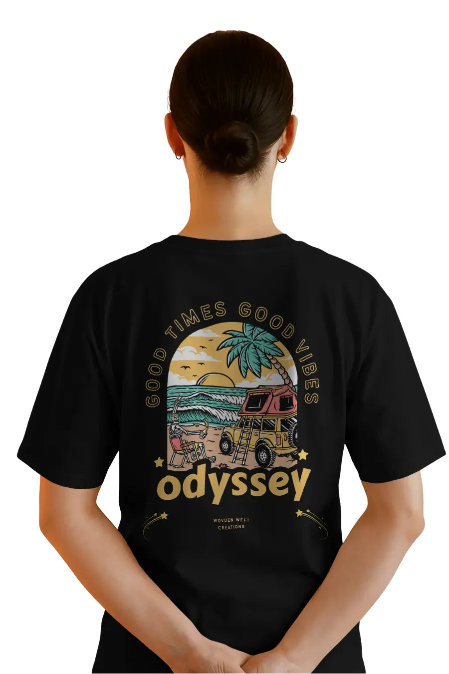 Back view of woman in black relaxed fit t-shirt with Odyssey beach van and sunset design
