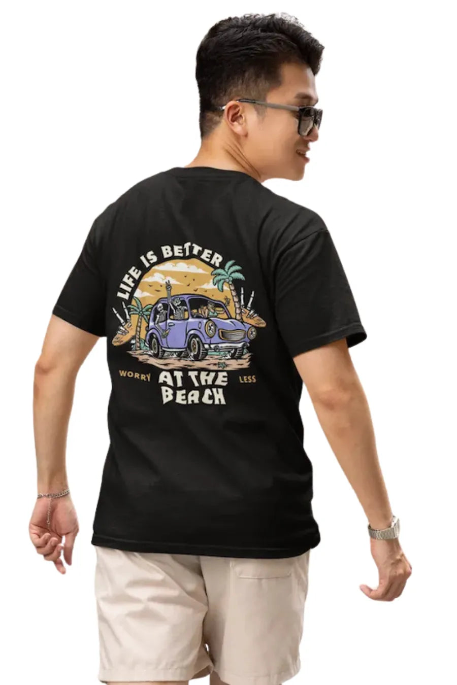 Man wearing a Black Double Impact T-shirt with beach skeleton and travel car design