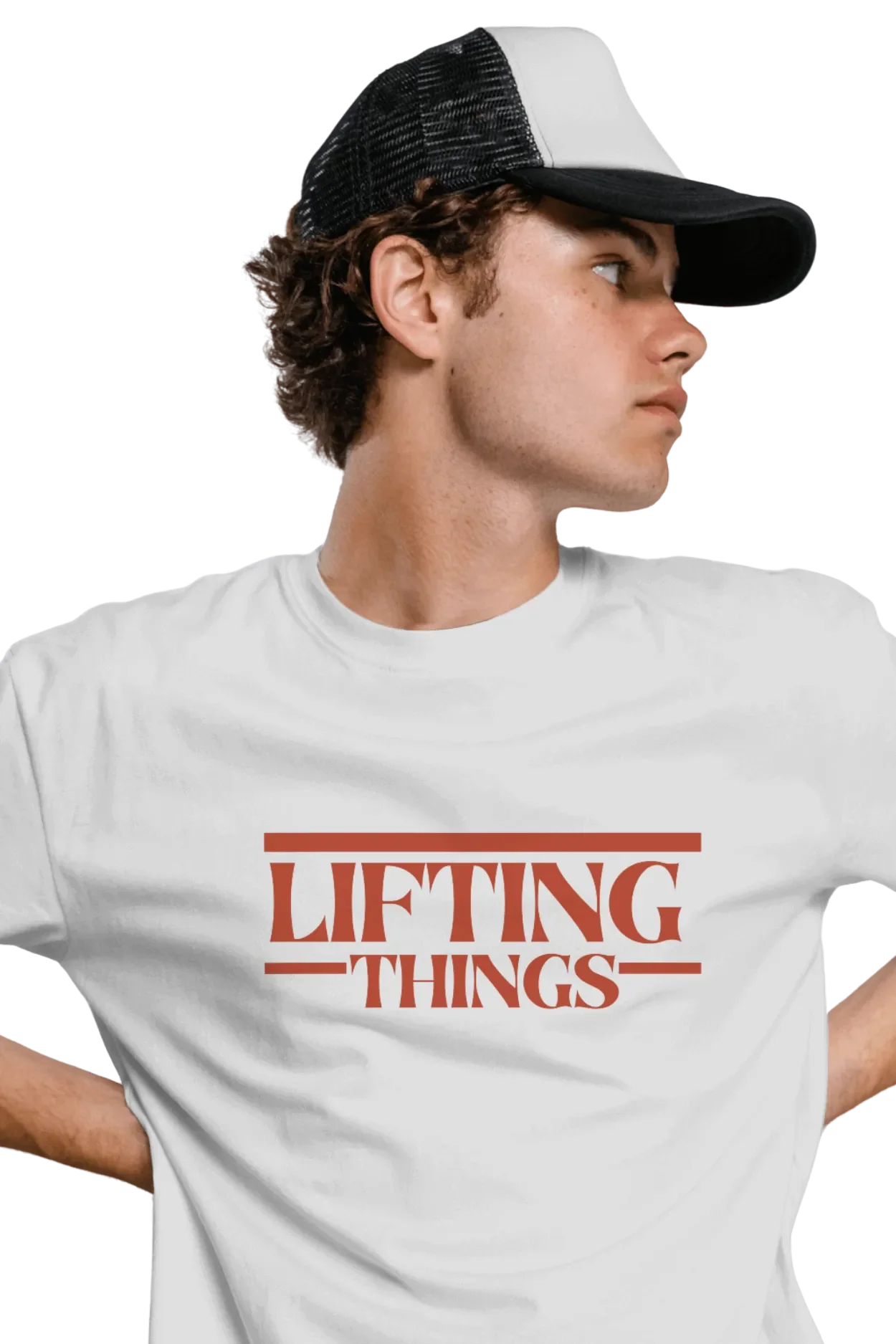 Young man wearing an off-white cotton t-shirt with “Lifting Things” text printed in bold red font.