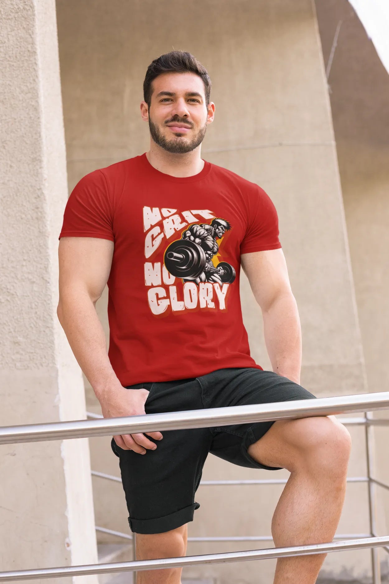 Man wearing red cotton t-shirt with “No Grit No Glory” quote and muscular weightlifter graphic, leaning on railing in outdoor urban setting.