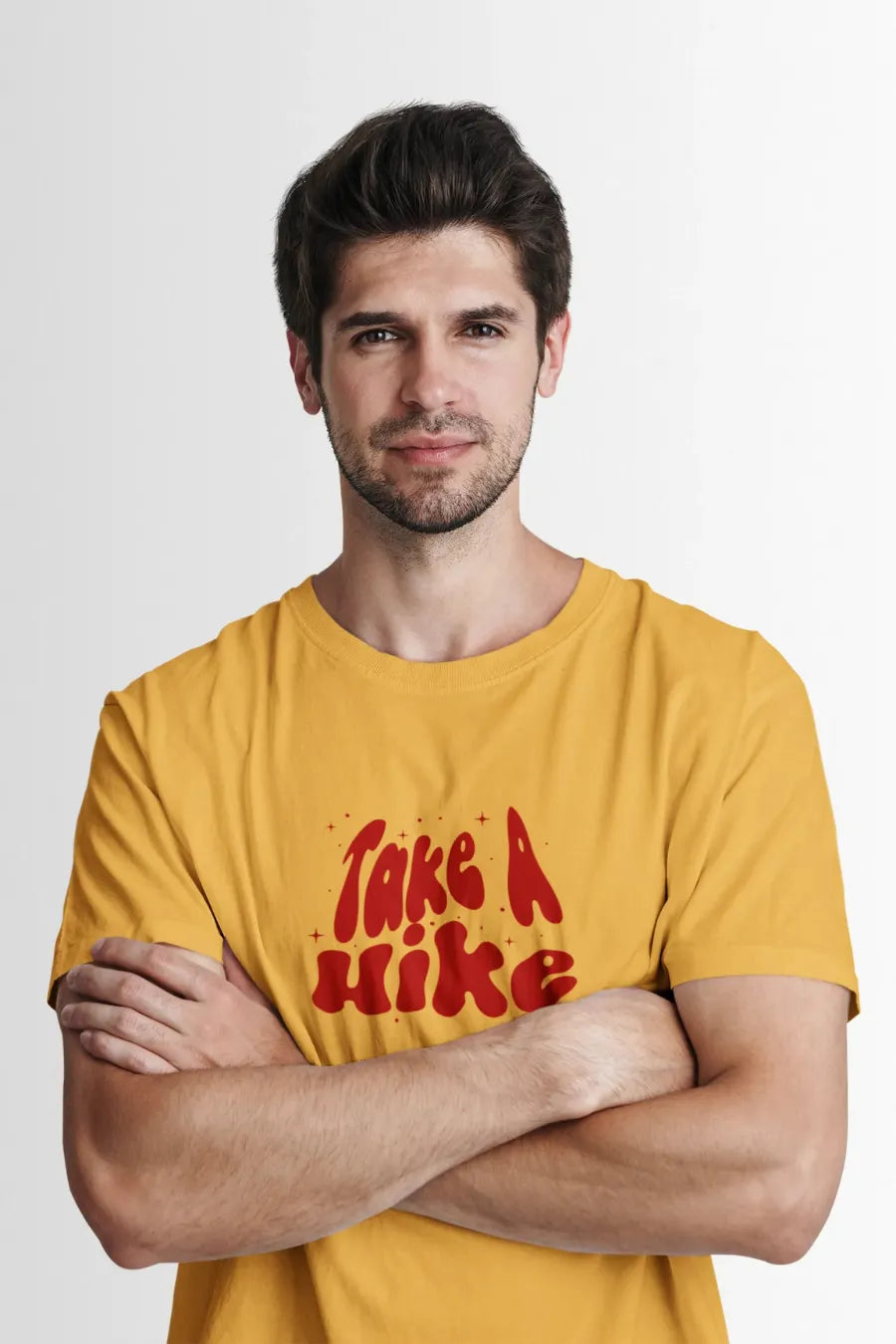 Man wearing a mustard Yellow T-shirt with red 'Take A Hike' graphic in vintage typography