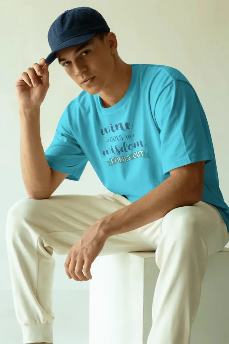 A man wearing a Sky blue t-shirt with wine quote saying Wine Goes In Wisdom Comes Out