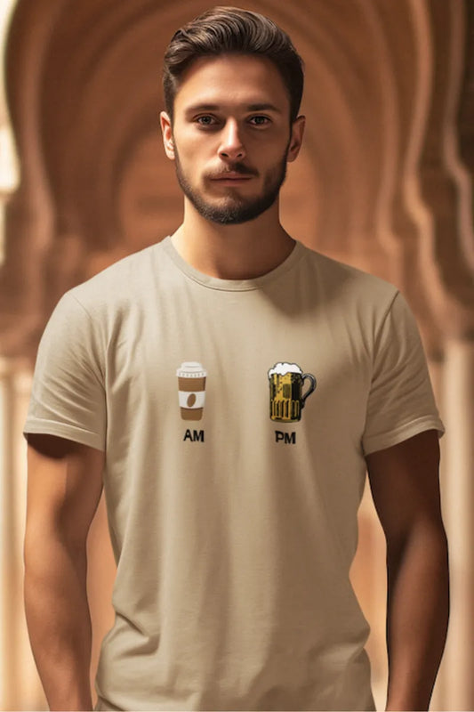 A man wearing a Beige brown t-shirt with AM-PM print showing coffee in the morning and beer at night, worn by a male model.