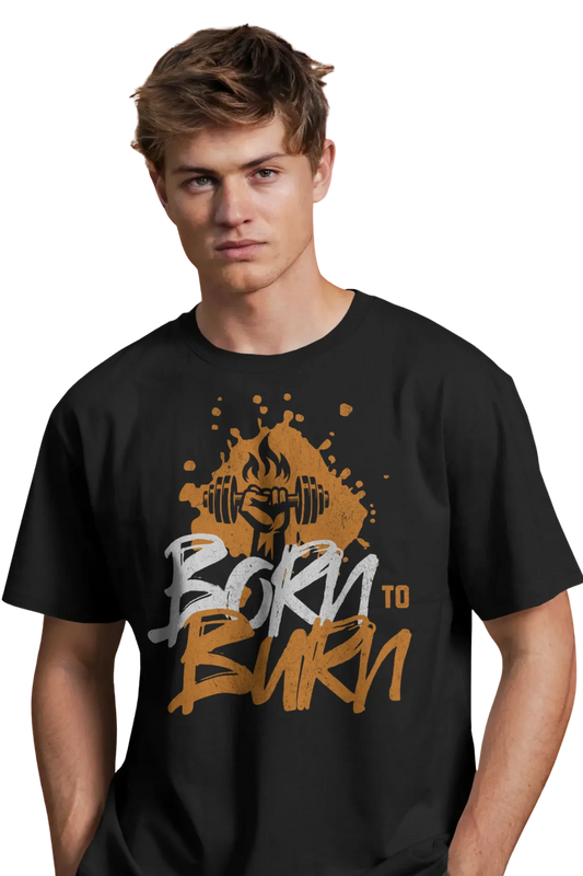 Young man wearing a black cotton t-shirt with "Born to Burn" graphic and a flaming dumbbell illustration, standing confidently with hands in pockets.
