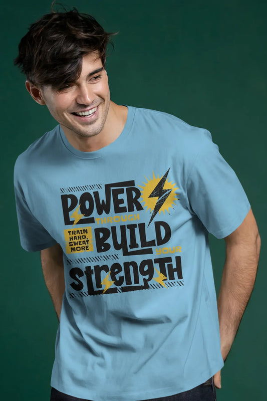 Man wearing a sky blue t-shirt with motivational quote “Power Through Build Strength – Train Hard Sweat More” printed in bold text with yellow highlights.