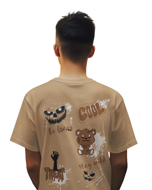 Man wearing beige brown cotton t-shirt with horror-themed doodles, stitched teddy bear, and quotes like “COOL” and “Stay Wild” printed on the back.