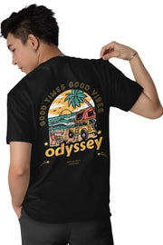 Man wearing a black double impact T-shirt with 'Good Times Good Vibes' text on front and colorful 'Odyssey' beach van graphic on back.