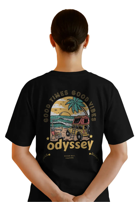 Back view of woman in black relaxed fit t-shirt with Odyssey beach van and sunset design