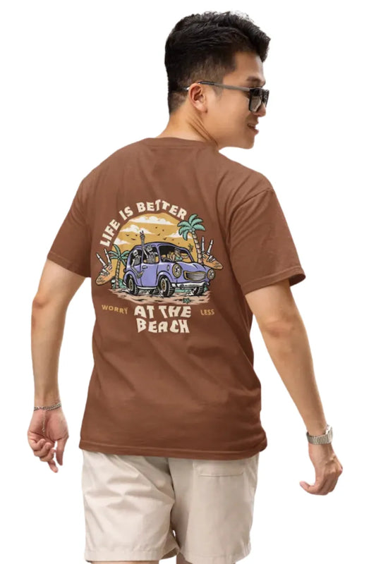 Man wearing a rust brown Double Impact T-shirt with beach skeleton and travel car design