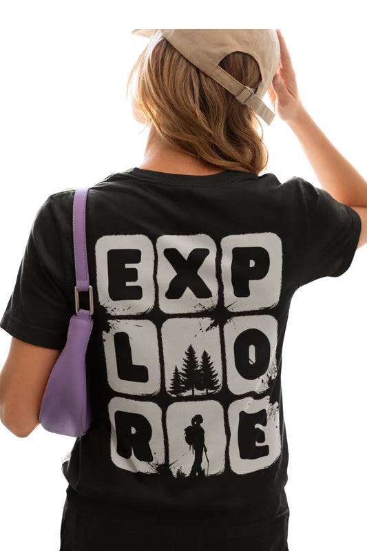 Woman in black relaxed-fit t-shirt with bear cartoon holding map and 'Explore' text