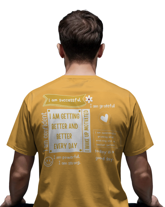 Man wearing mustard yellow t-shirt with motivational quotes like “I am confident,” “I am successful,” and “Getting better every day” printed on the back and front.