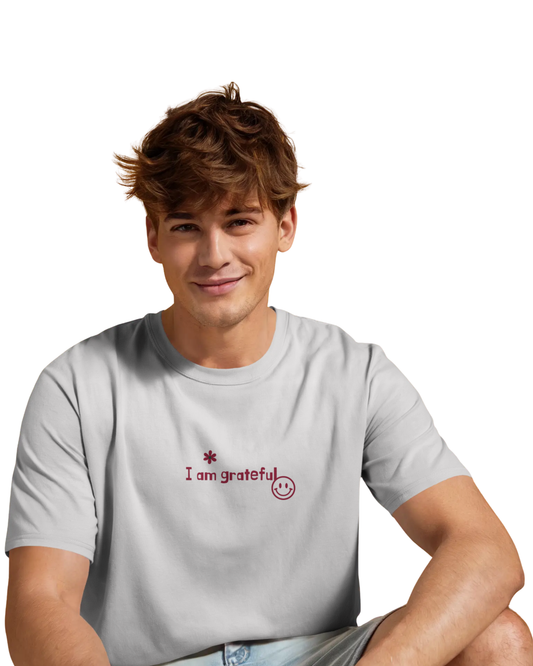Man wearing an off-white cotton t-shirt with motivational affirmations like “I am successful,” “I am confident,” and “Better every day” printed on the back and front.