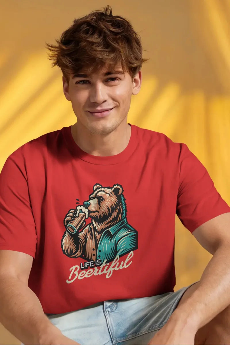 A man wearing a Man wearing red t-shirt with 'Life is Beertiful' graphic of a bear drinking beer