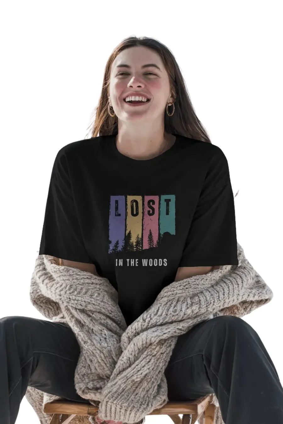 Woman smiling in black oversize t-shirt with colorful forest and 'Lost in the Woods' print
