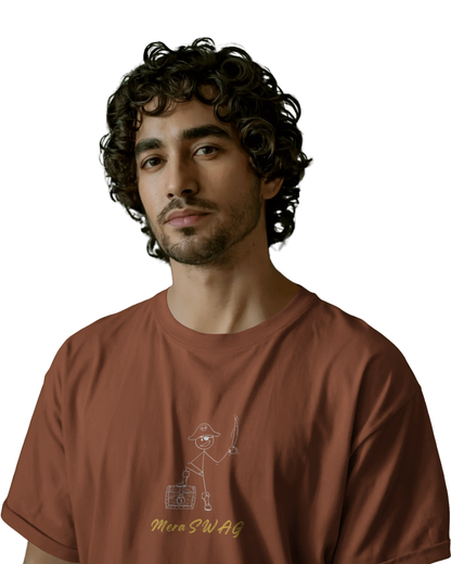 Man wearing a rust brown t-shirt with cartoon doodles and quirky words like “MERA SWAG”, “CHOOSE!”, “LOL”, and “BAM BAM” printed on the back and front.