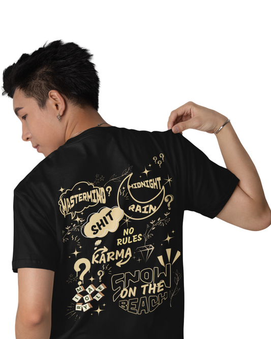 Man wearing a black cotton t-shirt with quirky graphic quotes like “Midnight Rain,” “Karma,” and “Snow on the Beach” printed in cream on the back and front.