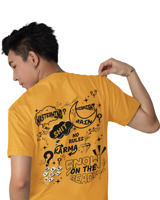 Man wearing a mustard yellow cotton t-shirt with doodle-style text like “Karma,” “Midnight Rain,” and “Snow on the Beach” printed on the back and front.