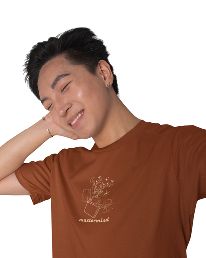 Man wearing rust brown cotton t-shirt with multiple playful quotes like “Snow on the Beach,” “Midnight Rain,” and “Karma” printed.
