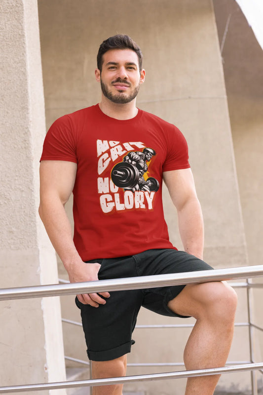 Man wearing red cotton t-shirt with “No Grit No Glory” quote and muscular weightlifter graphic, leaning on railing in outdoor urban setting.
