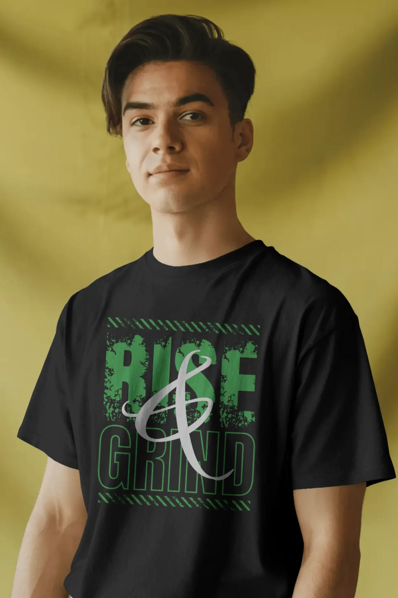 Man wearing a black cotton t-shirt with green distressed text “Rise & Grind” printed on the front. T-shirt has a regular and relaxed fit.