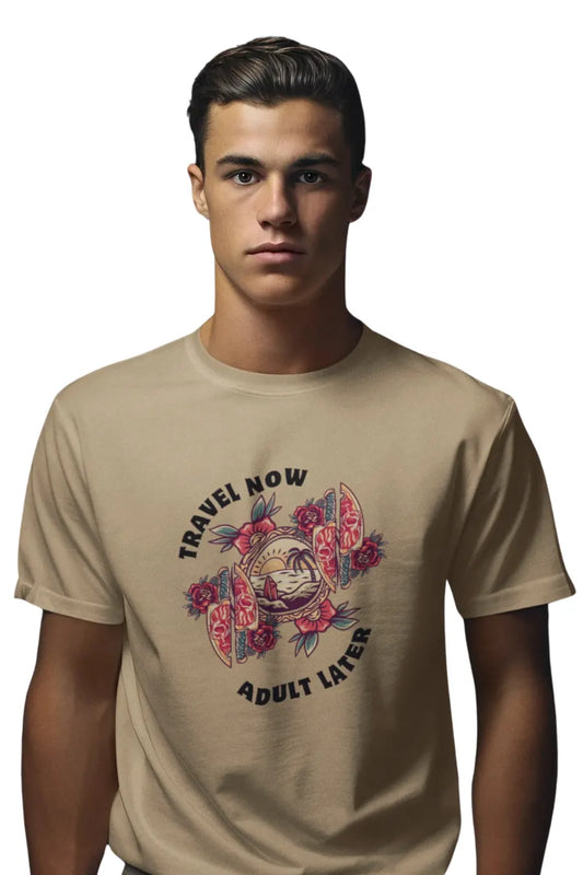 Man wearing a Beige Brown T-shirt with 'Travel Now Adult Later' graphic design featuring sunset, waves, and floral elements