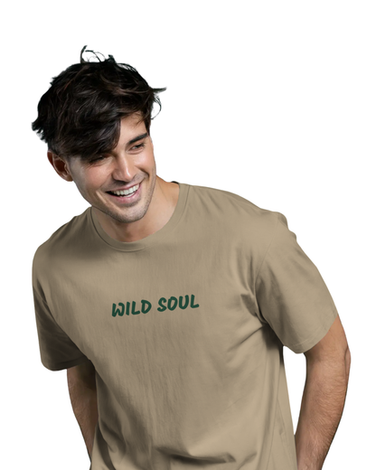 Man wearing a beige brown shade cotton t-shirt with a green leopard face design and the quote “WILD SOUL” printed on the back and front in bold letters.
